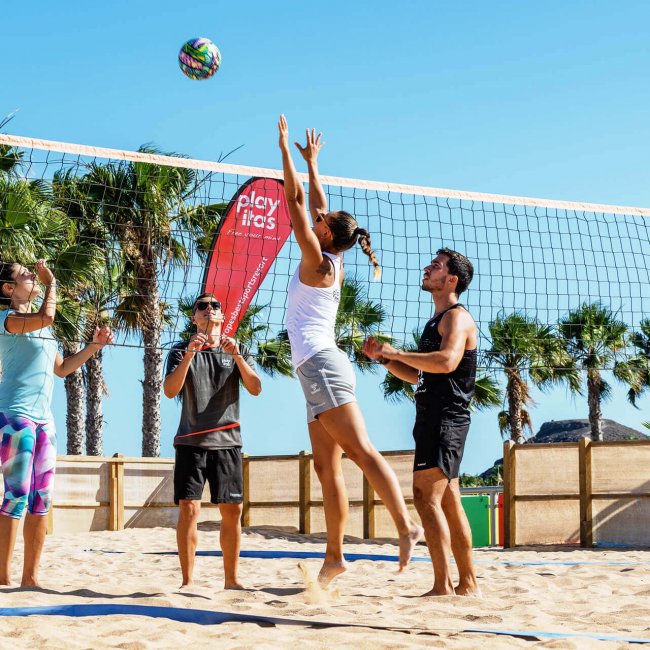 People playing beach volleyball